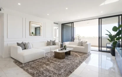 Luxury apartment for sale in Tangier – bright living room with white bouclé sofas and city balcony