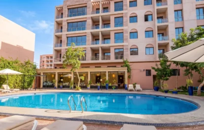 Hotel for sale in Marrakech with outdoor pool, sun loungers and landscaped garden terrace