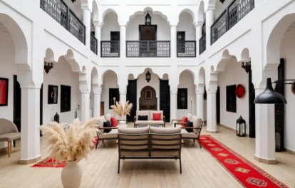 Elegant riad for rent in Tangier with Moorish arches, white columns and traditional seating