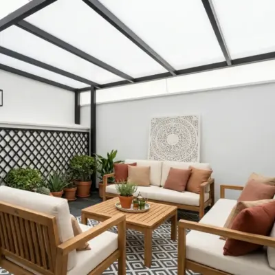 Covered terrace of the Asilah loft with teak outdoor lounge set, potted plants, patterned floor tiles and pergola roof