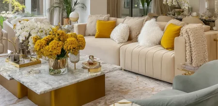 Buy an apartment in Casablanca: luxury living room with cream sofas, gold marble table, and vibrant yellow flower bouquets.